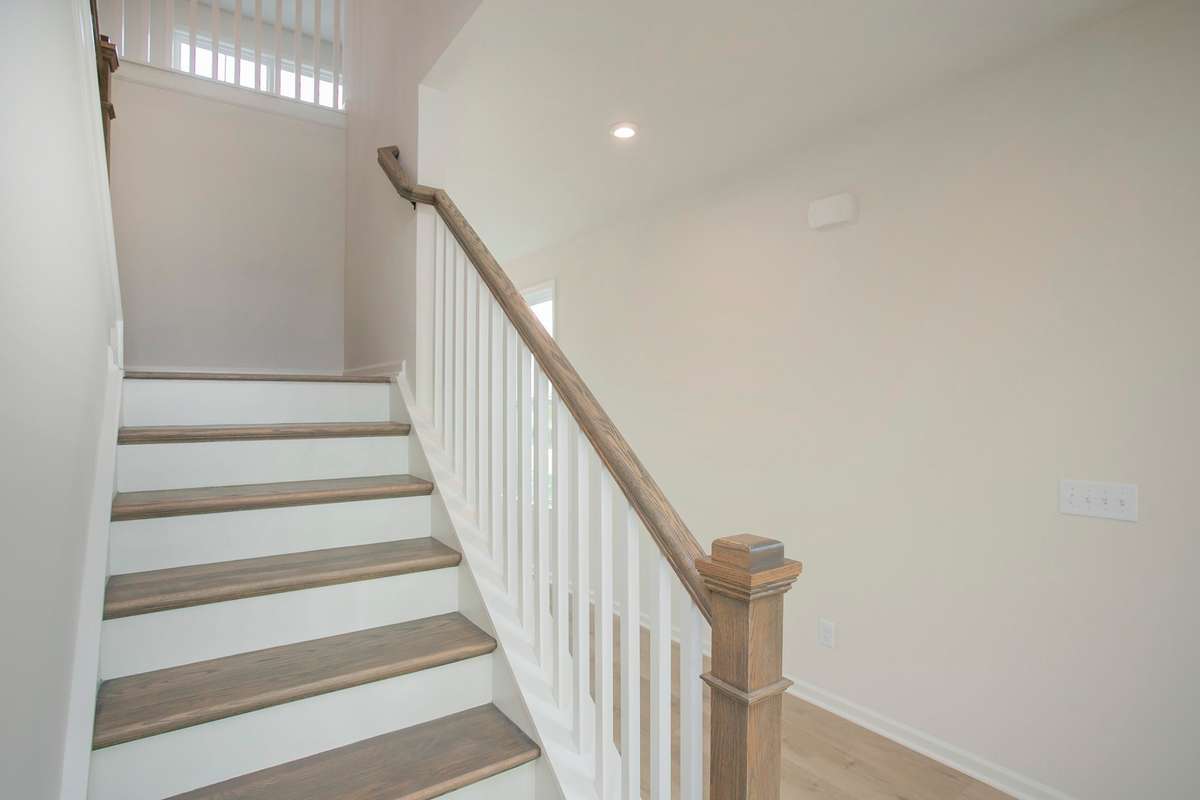 All photos are of model home*  Oak Treads on the stairs are included w/iron railing.