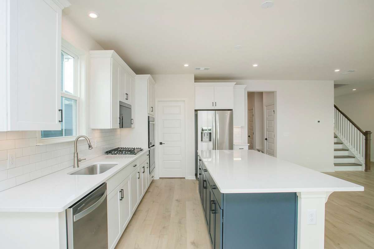 Backsplash and quartz countertops are included options. All photos are of model home*