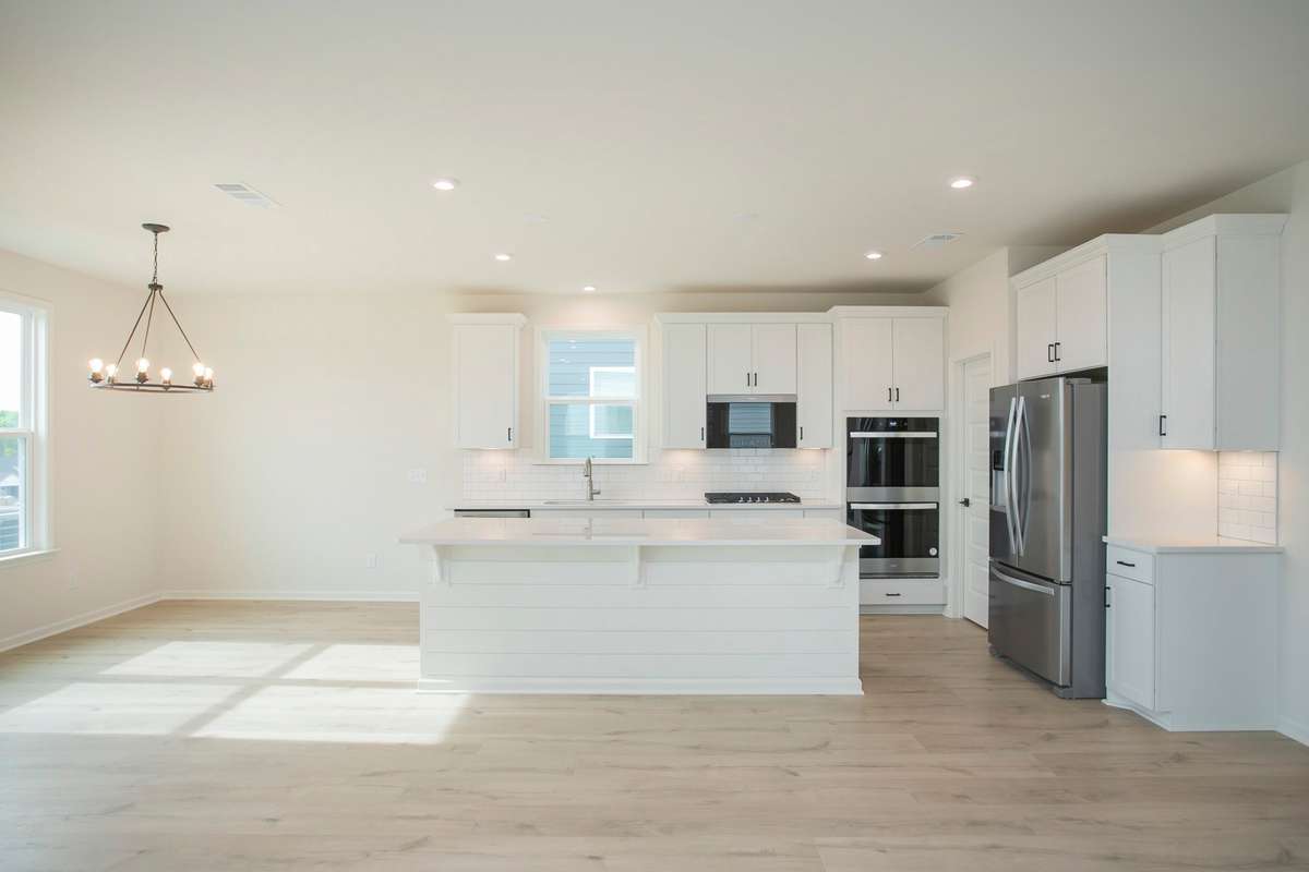All photos are of model home* Gourmet Kitchen is included with a Wood Hood and Cooktop, Wall Oven/Microwave.