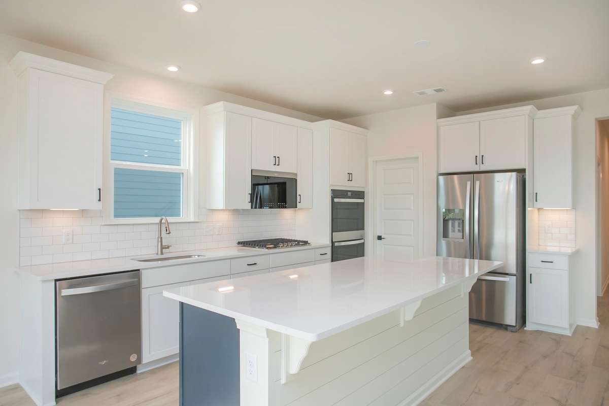 All photos are of model home* Gourmet Kitchen is included with a Wood Hood and Cooktop, Wall Oven/Microwave.