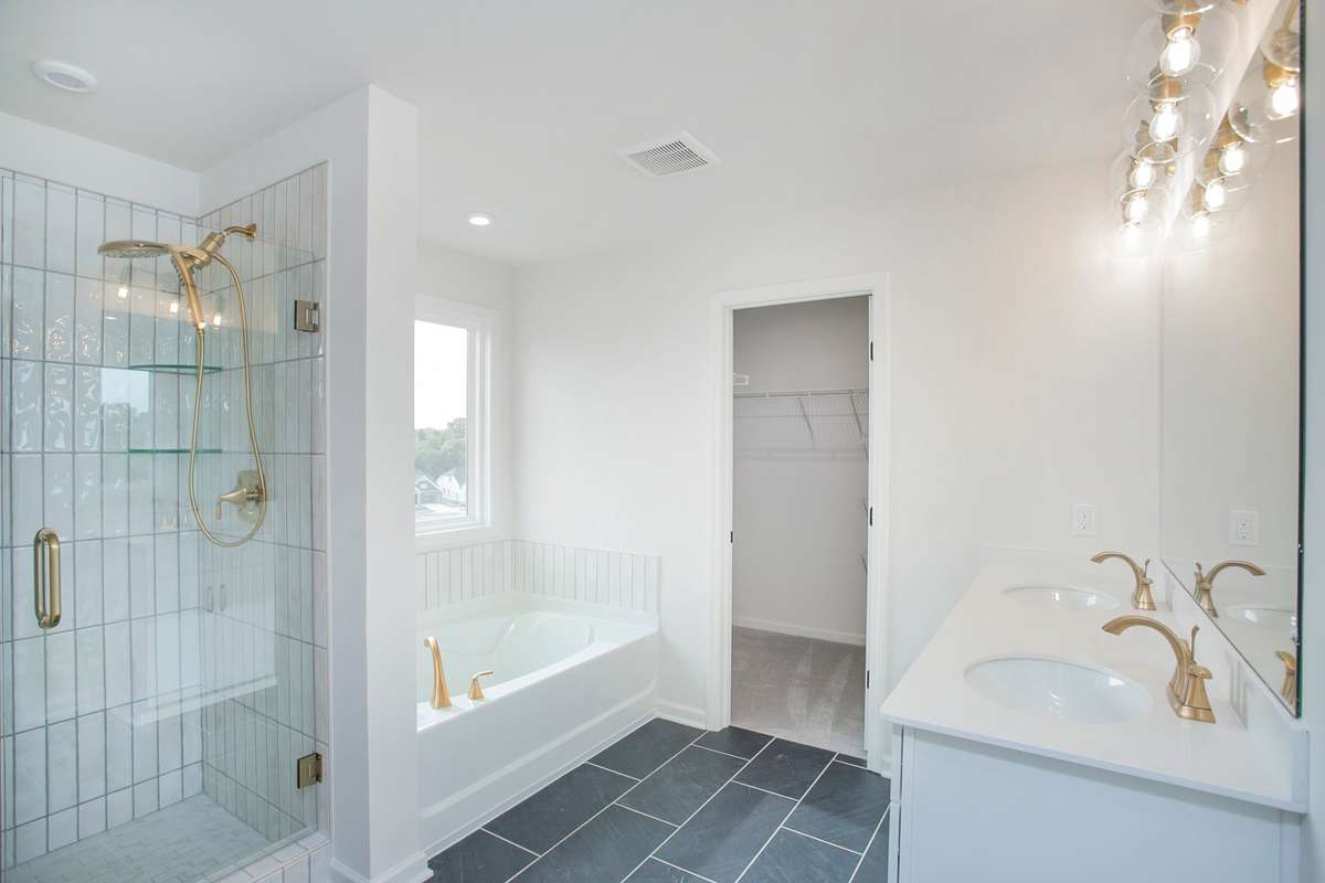 Primary Bathroom. Separate tub and shower shown, but this home includes a larger Shower only! All photos are of model home*