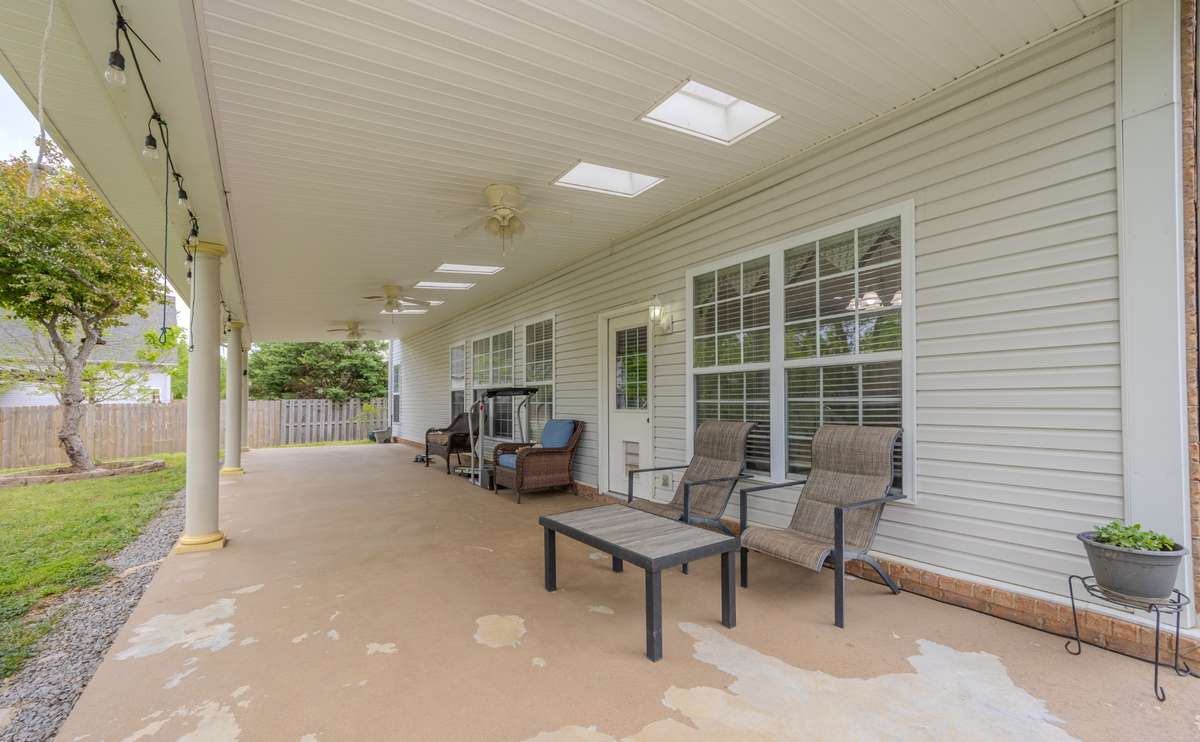 Huge covered back porch with skylights and ceiling fans.