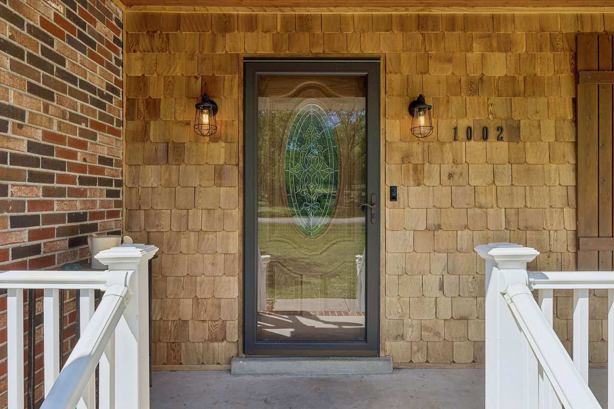 Instant curb appeal… this charming front porch with cedar shingles sets the tone for everything inside.