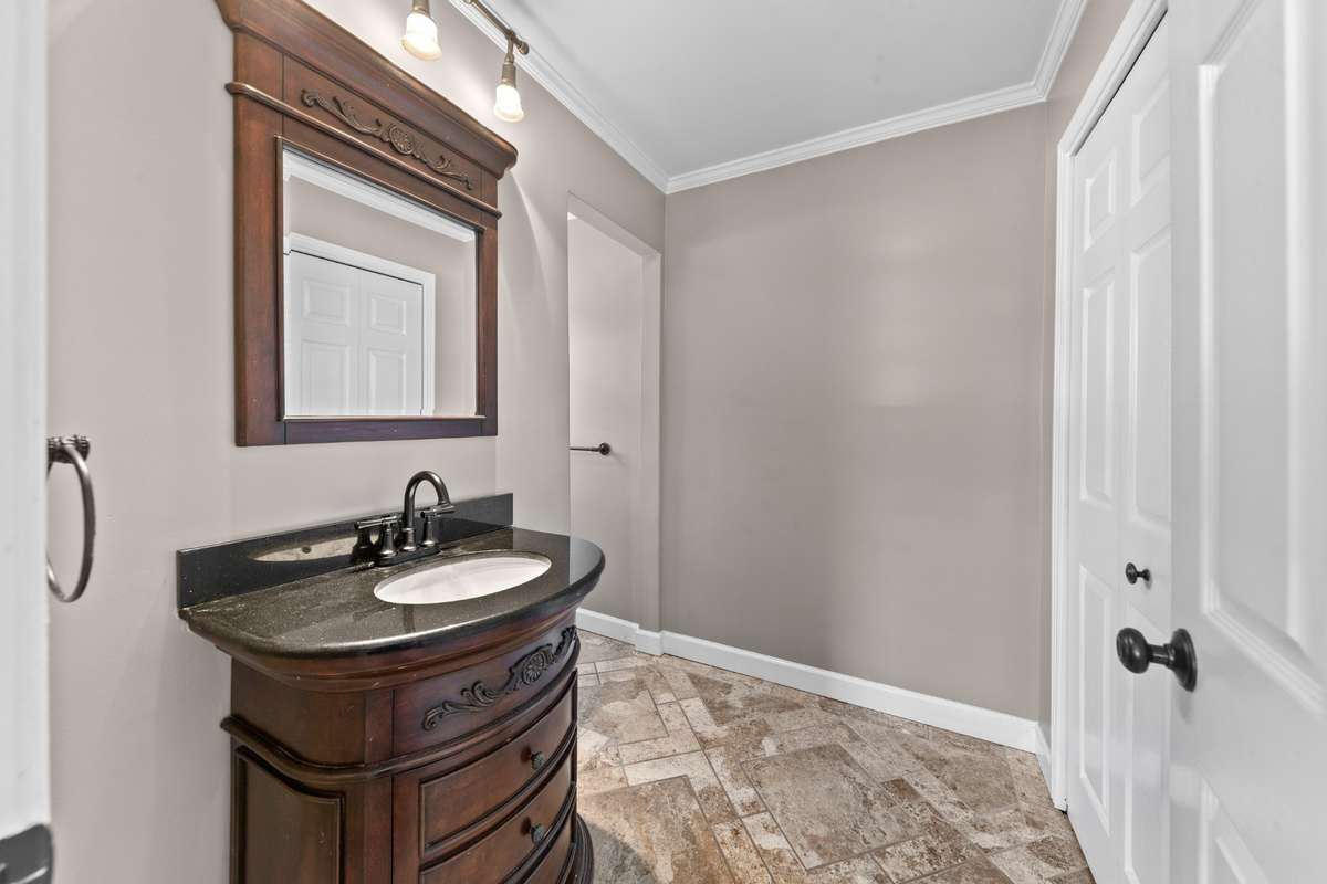 Thoughtful primary bath with custom finishes and closet convenience.
