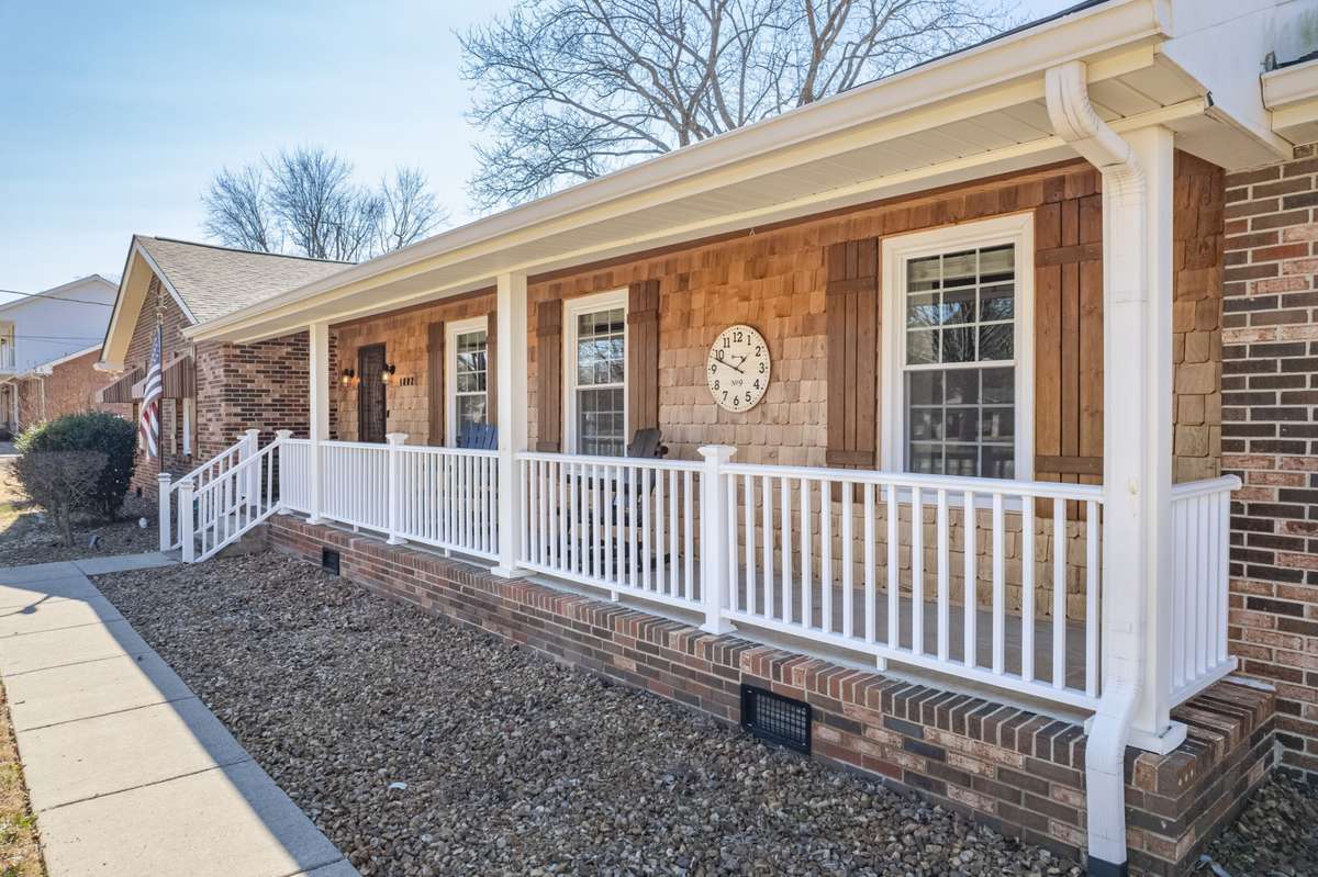 Storybook charm starts right here… this adorable front porch with cedar shingles is as inviting as it gets. 