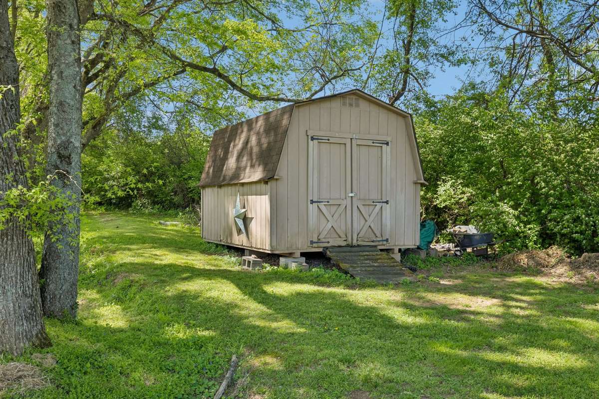 Storage shed conveys with the property and is ideal for keeping lawn equipment and outdoor tools neatly organized.
