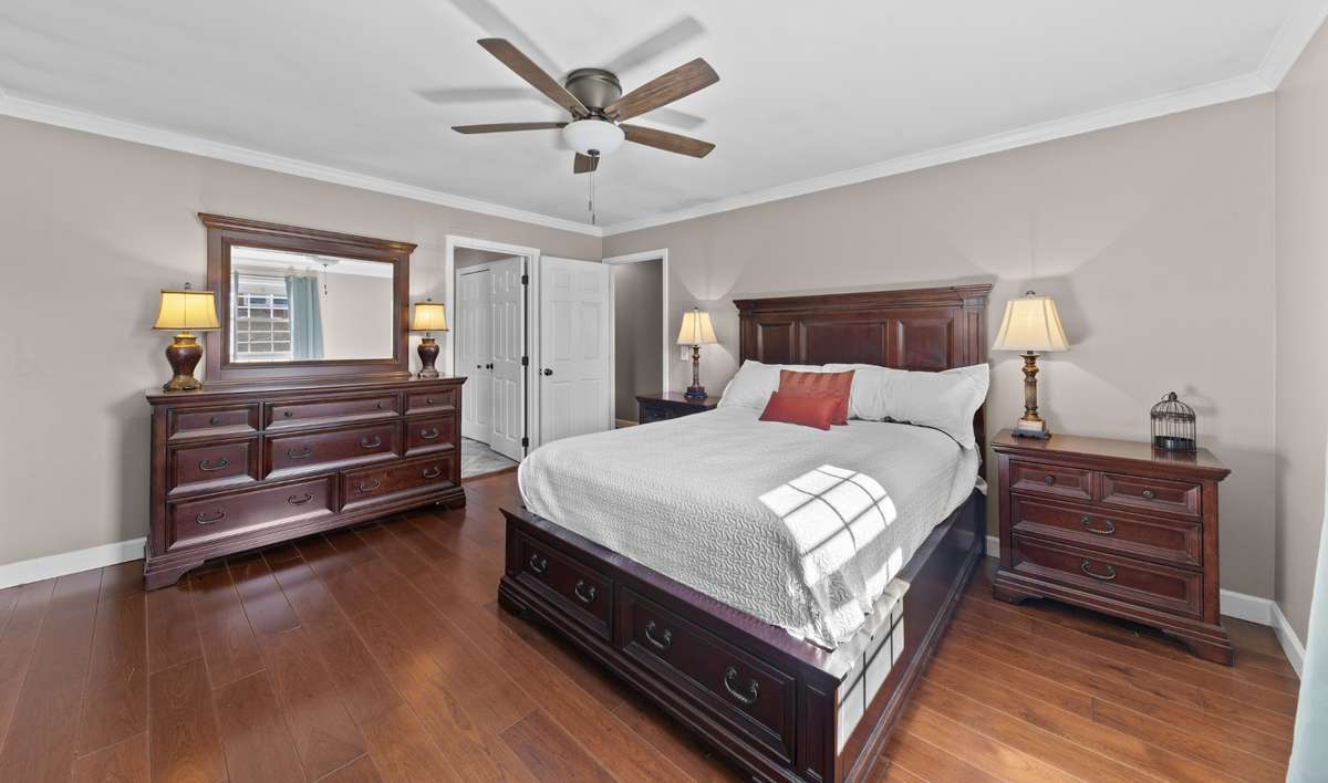 Lovely primary bedroom with wood floors and beautiful natural light. (15x13)