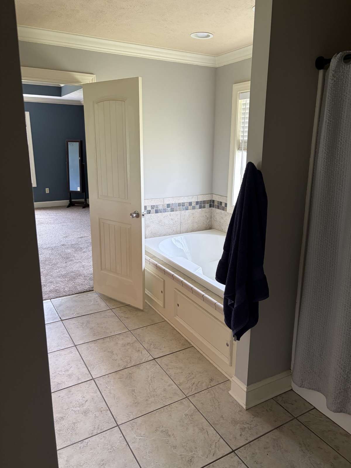 Main bathroom with his and hers closets and enclosed toilet area