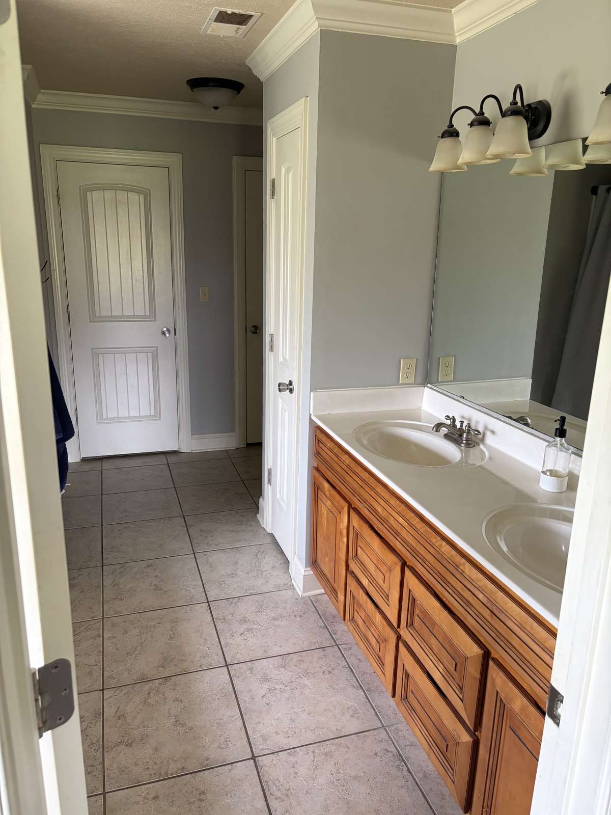 Main bath with whirlpool tub, shower, and dual vanity sink