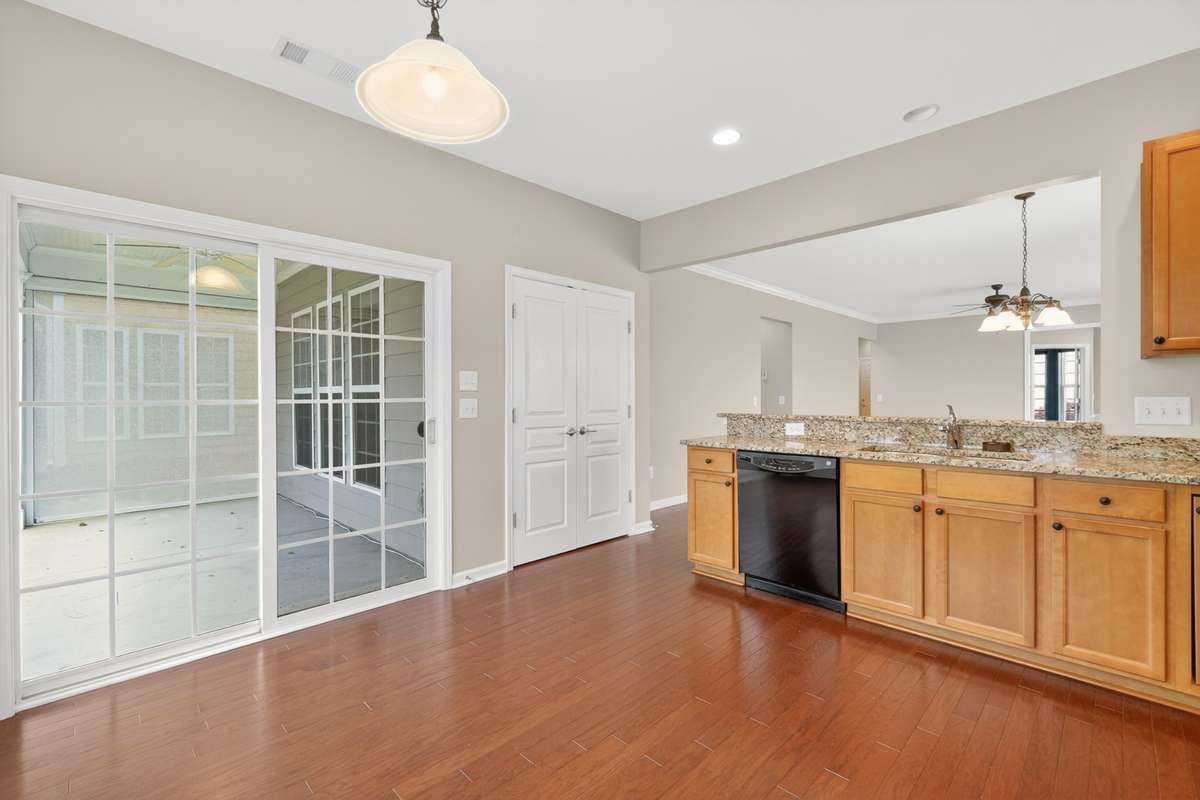 Glass sliding door out to covered patio area