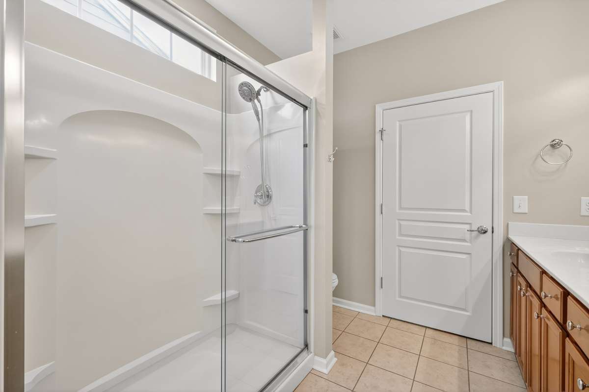 Large shower with glass door enclosure