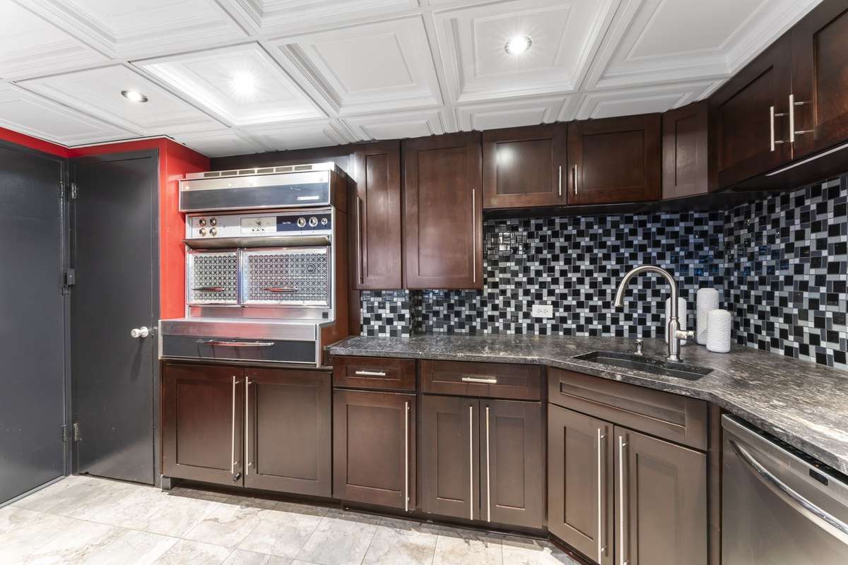 Ample cabinet space. Take a look at that vintage range. Range drawer opens for access to the four burners. Two ovens. A showstopper.