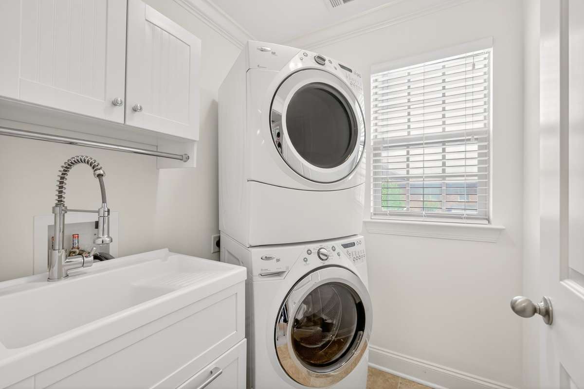 Laundry room with sink and cabinet for increased storage.