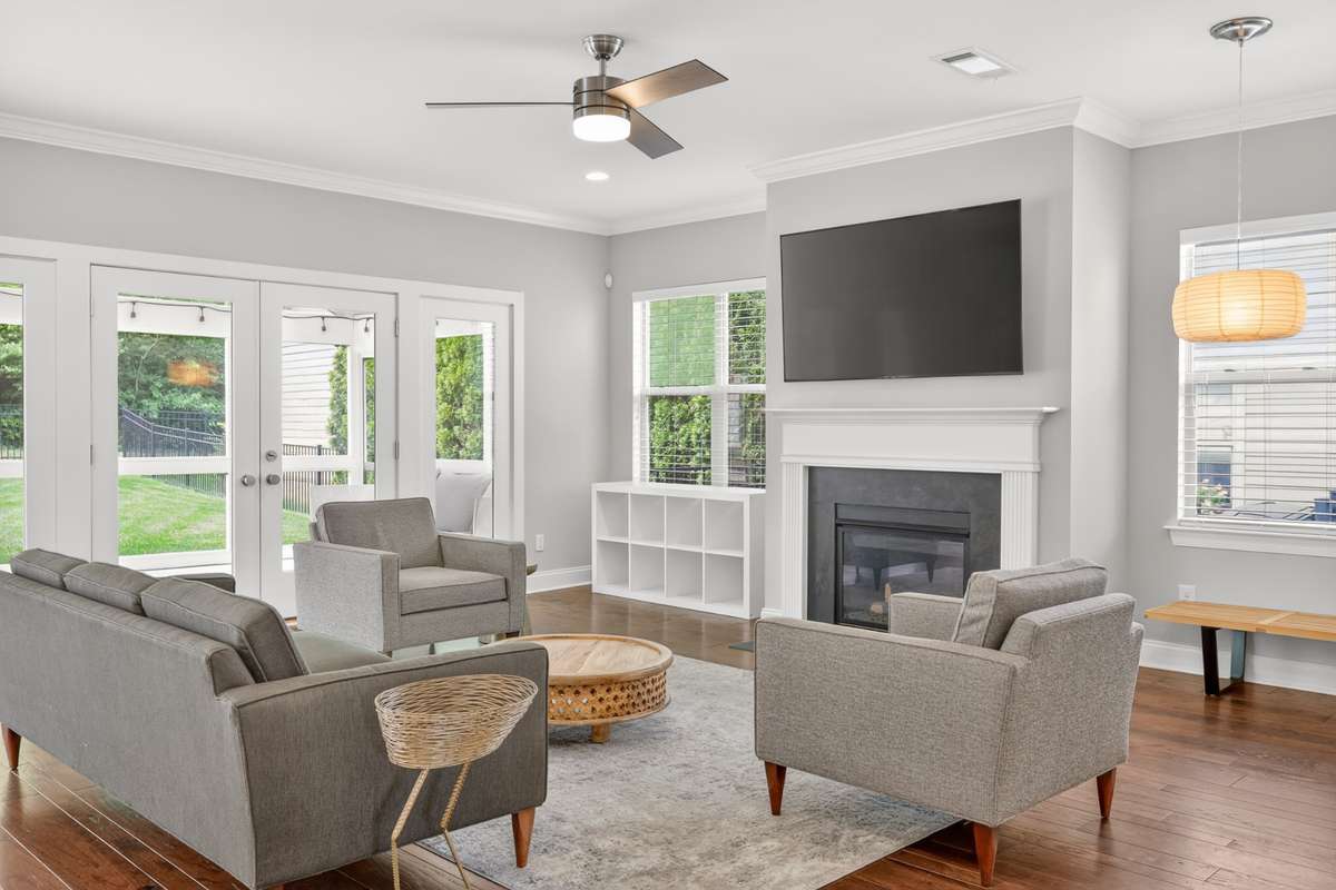 Cozy gas fireplace and plenty of nature light. Doors lead to screened in porch.