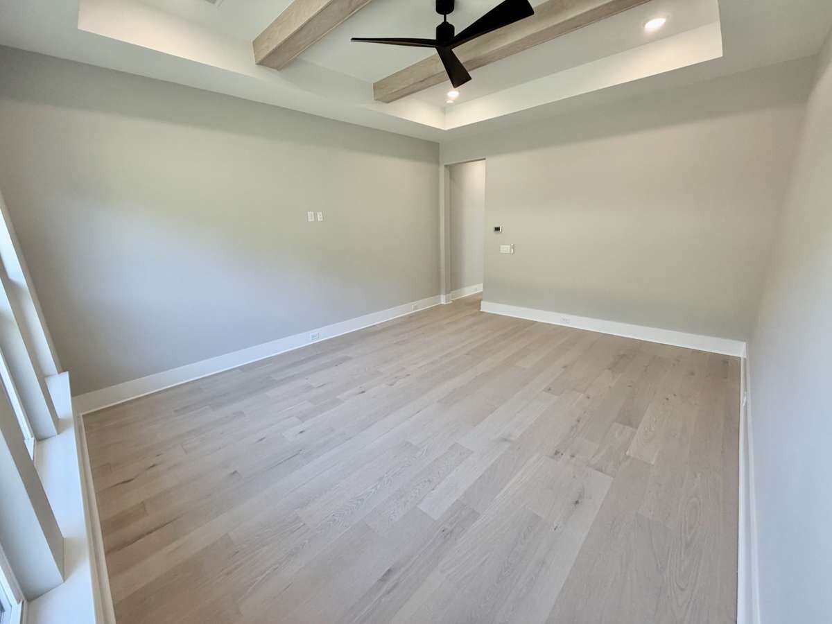 Actual Home — Primary Bedroom with Trey Ceilings & Wood Beams.