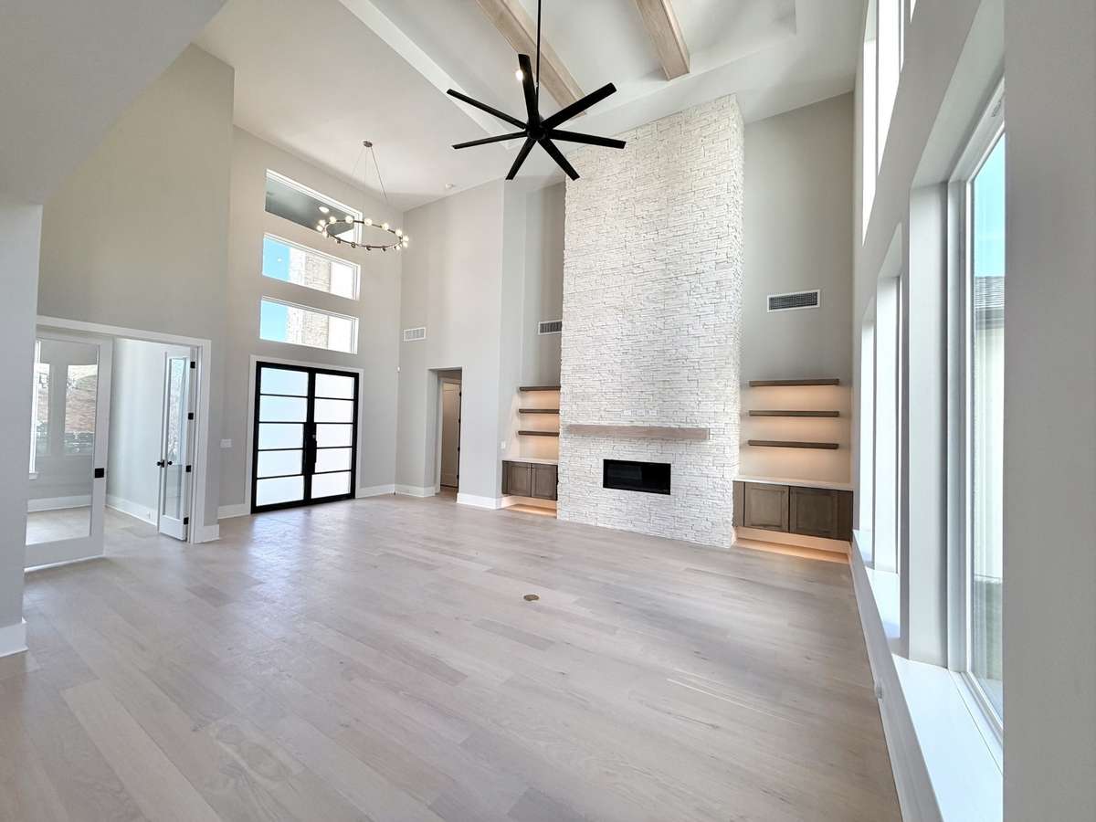 Step inside and experience SOARING ceilings, clean architectural lines, expansive walls of windows, and open, light-filled spaces that create a seamless and comfortable flow. Actual Home Photo.