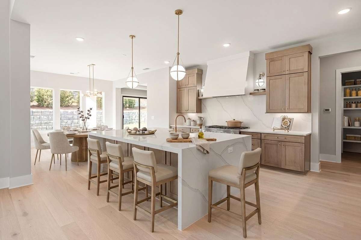 Whether hosting elegant gatherings or enjoying relaxed mornings at home, the flow between kitchen, dining, and great room creates a vibrant yet inviting atmosphere—where everyday moments feel extraordinary and entertaining feels effortless.