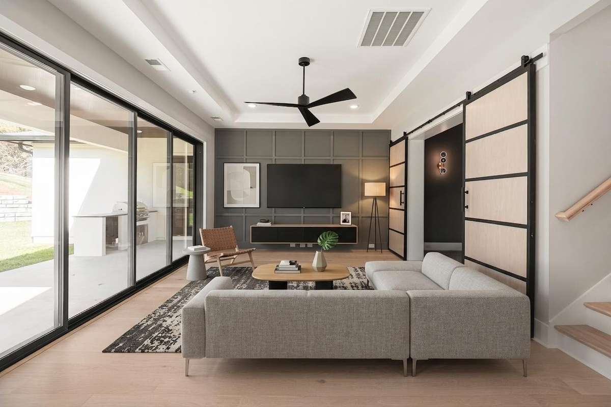Enjoy game day in style from your main level game room & media room, thoughtfully designed for comfort, fun, and effortless entertainment. Actual Home — Downstairs Game Room & Media Room — Virtually Staged for Inspiration