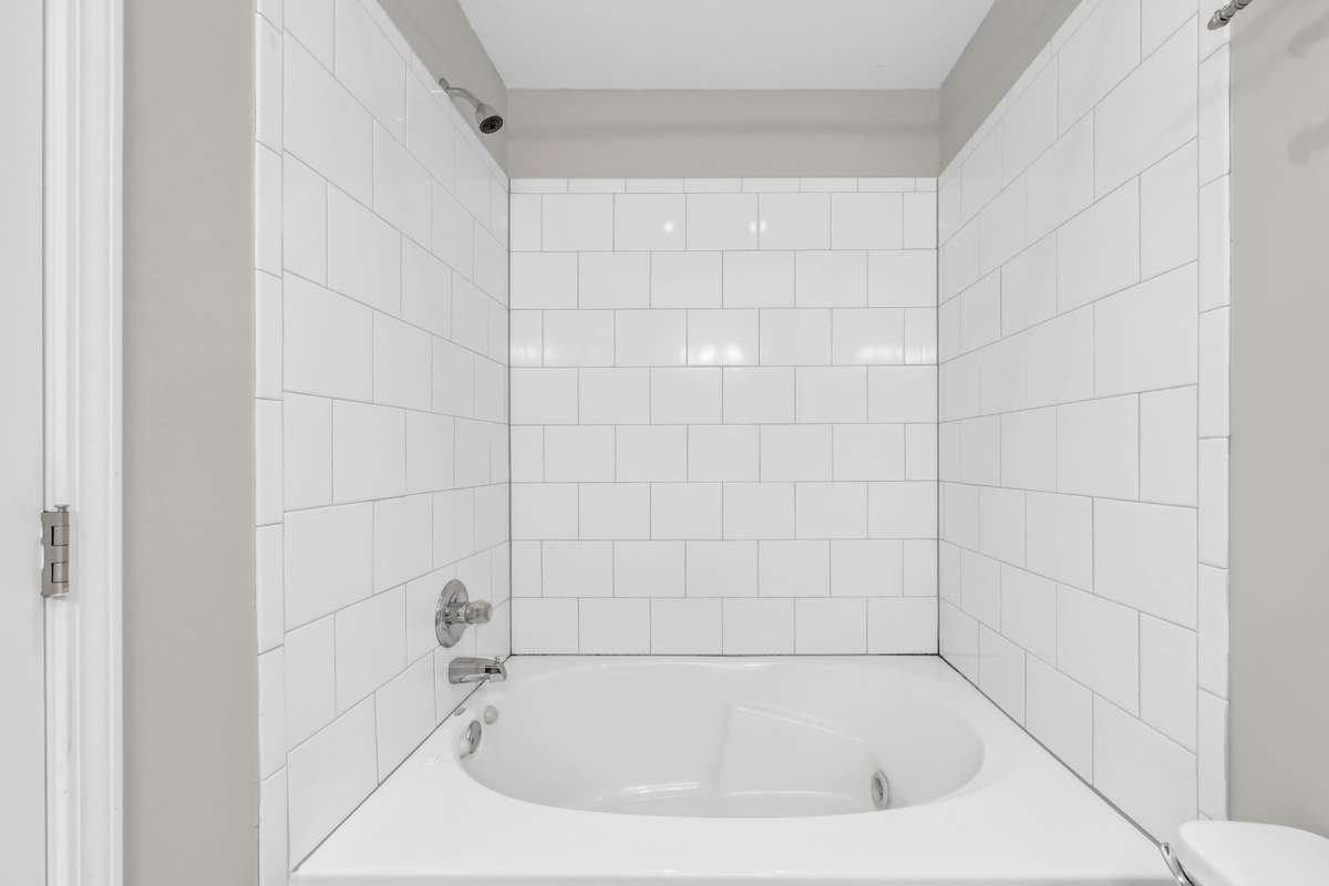 Check out the soaking tub upstairs with the tile surround.