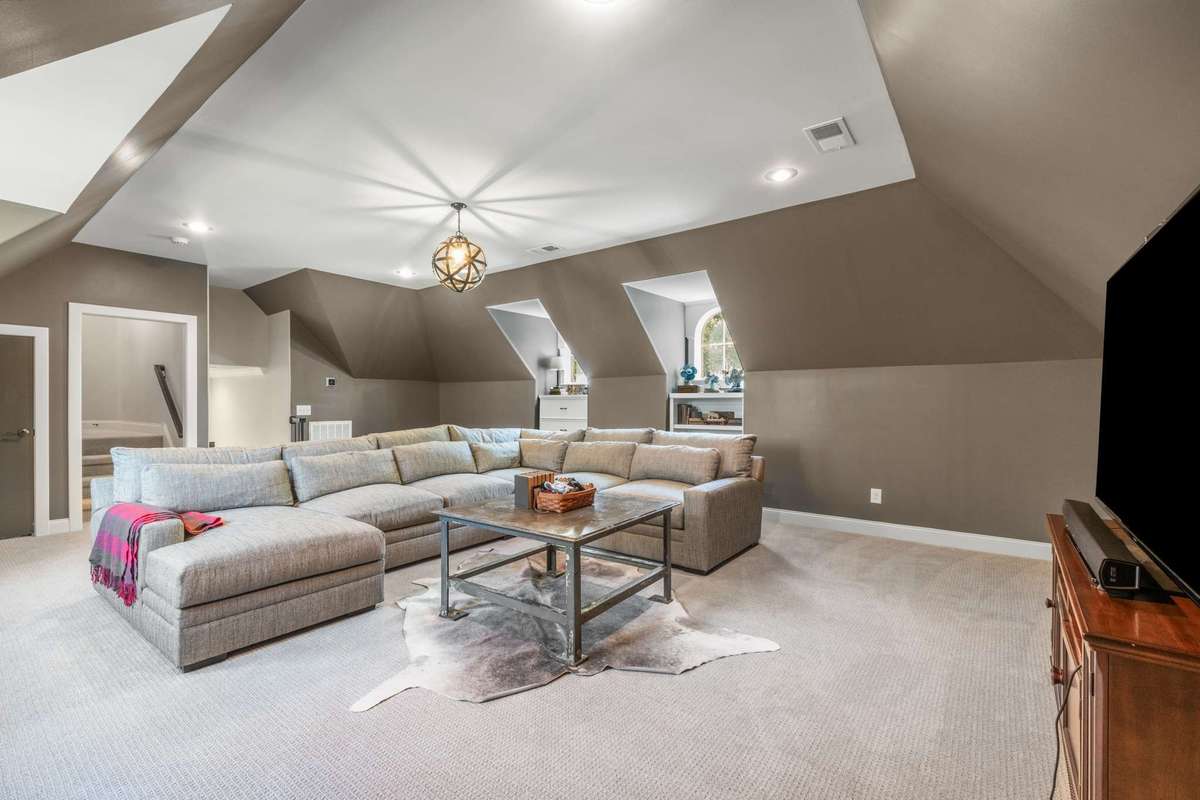 The 26x19 TV lounge bonus room is just a few steps up from the family room and kitchen hub
