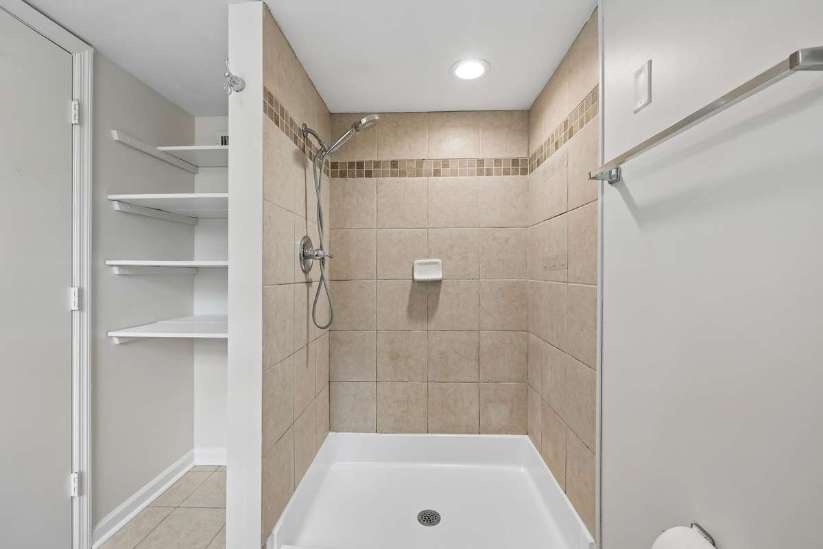 Features walk in shower and linen storage!