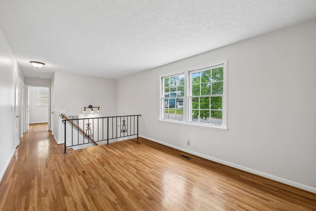 Just past the living room is 2 bedrooms and 1 full bathroom.