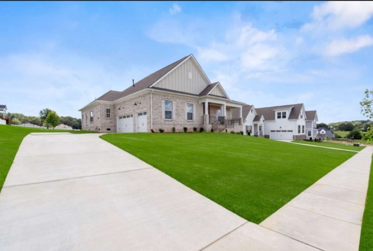 The front, sides, and 20 feet of the back yard of this house are fully sodded. Grass color is enhanced by AI.