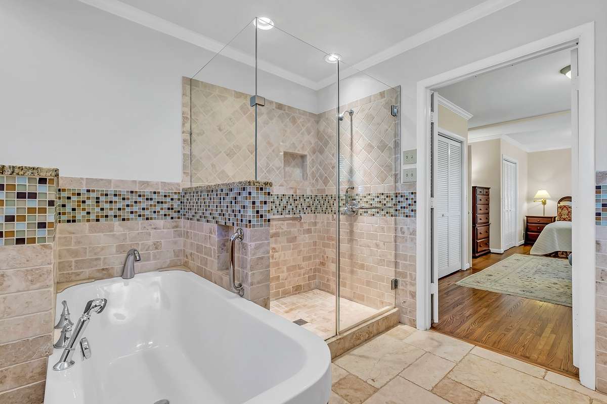 Spa soaking tub w/built-in shelf, heated marble floors, vanity w/2 sinks + tons of storage
