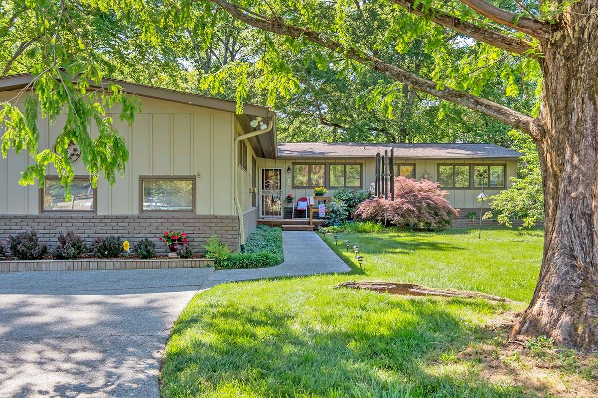 Lovingly landscaped with multiple gardens