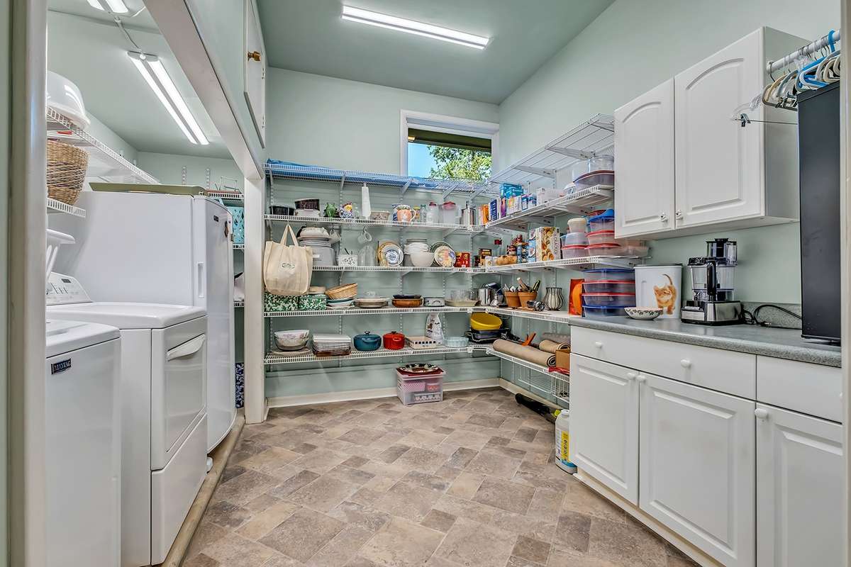 Huge laundry room/pantry w/built-in storage (would also make a great craft/workroom)