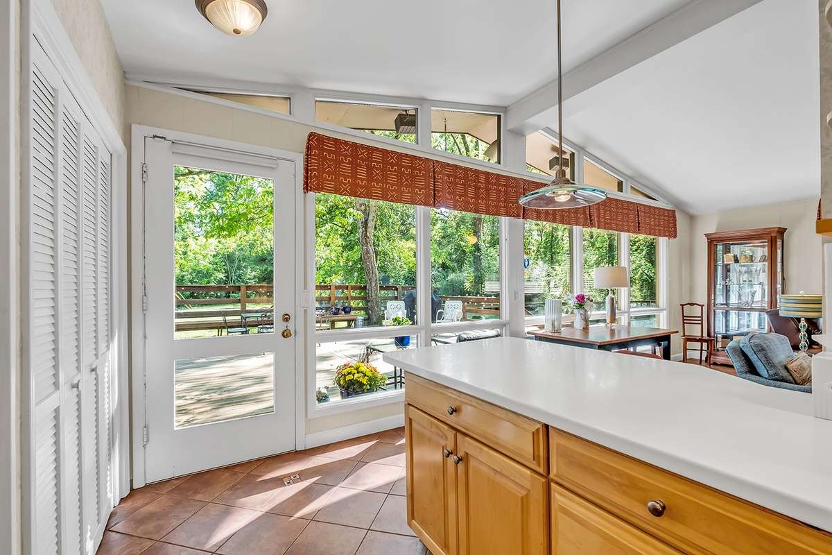 Floor-to-ceiling windows overlook the back deck