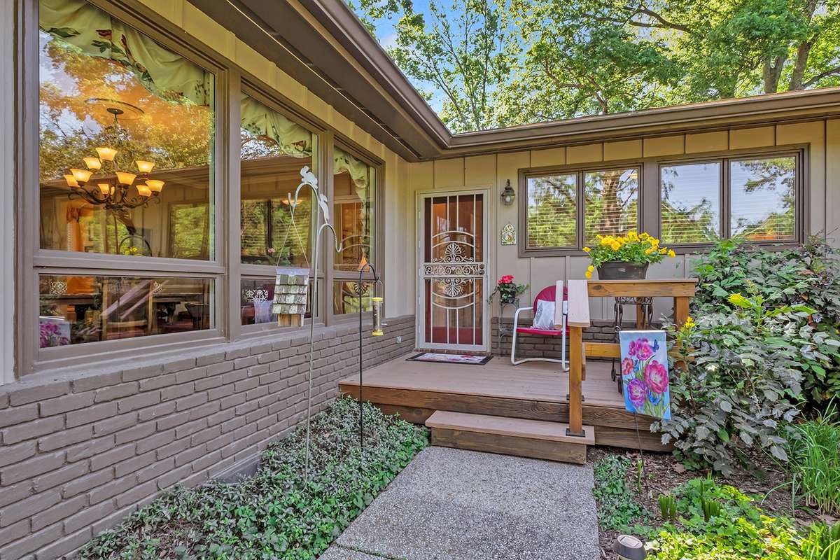 Home entry with rocking chair front porch