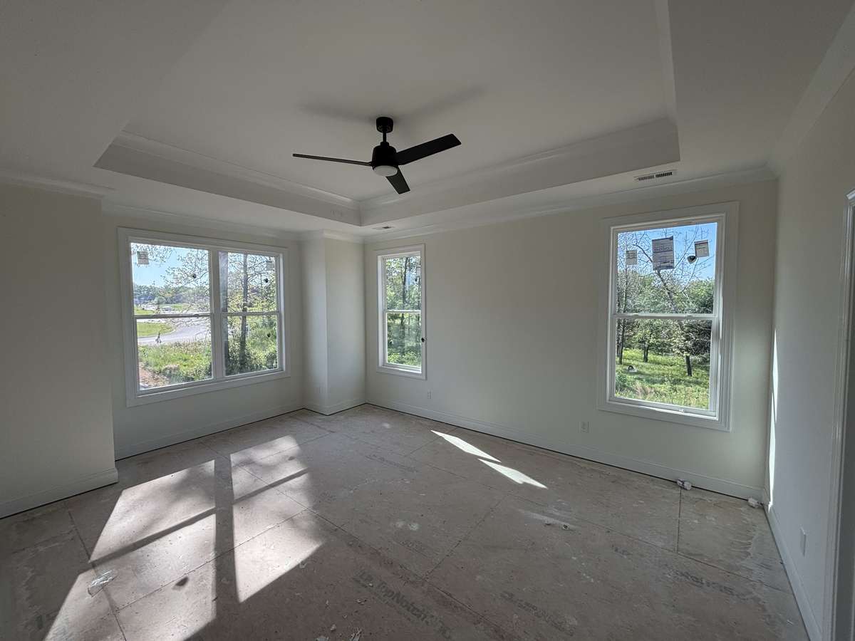 Primary bedroom with try ceiling