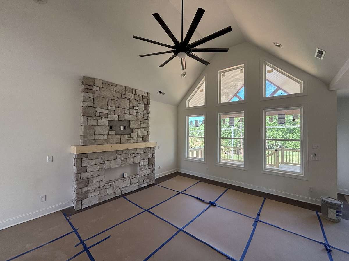 Great room with vaulted ceiling and stone fireplace
