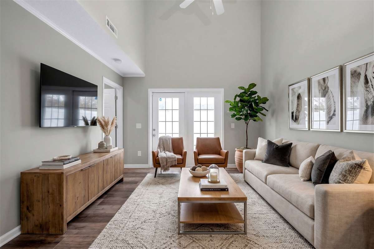 On the main level, you’ll find a convenient half bath, spacious living area, well-appointed kitchen, laundry area with washer and dryer, and access to both the garage and private patio.