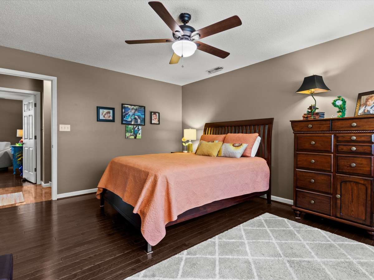 Bedroom- Wood flooring, ceiling fan, walk-in closet