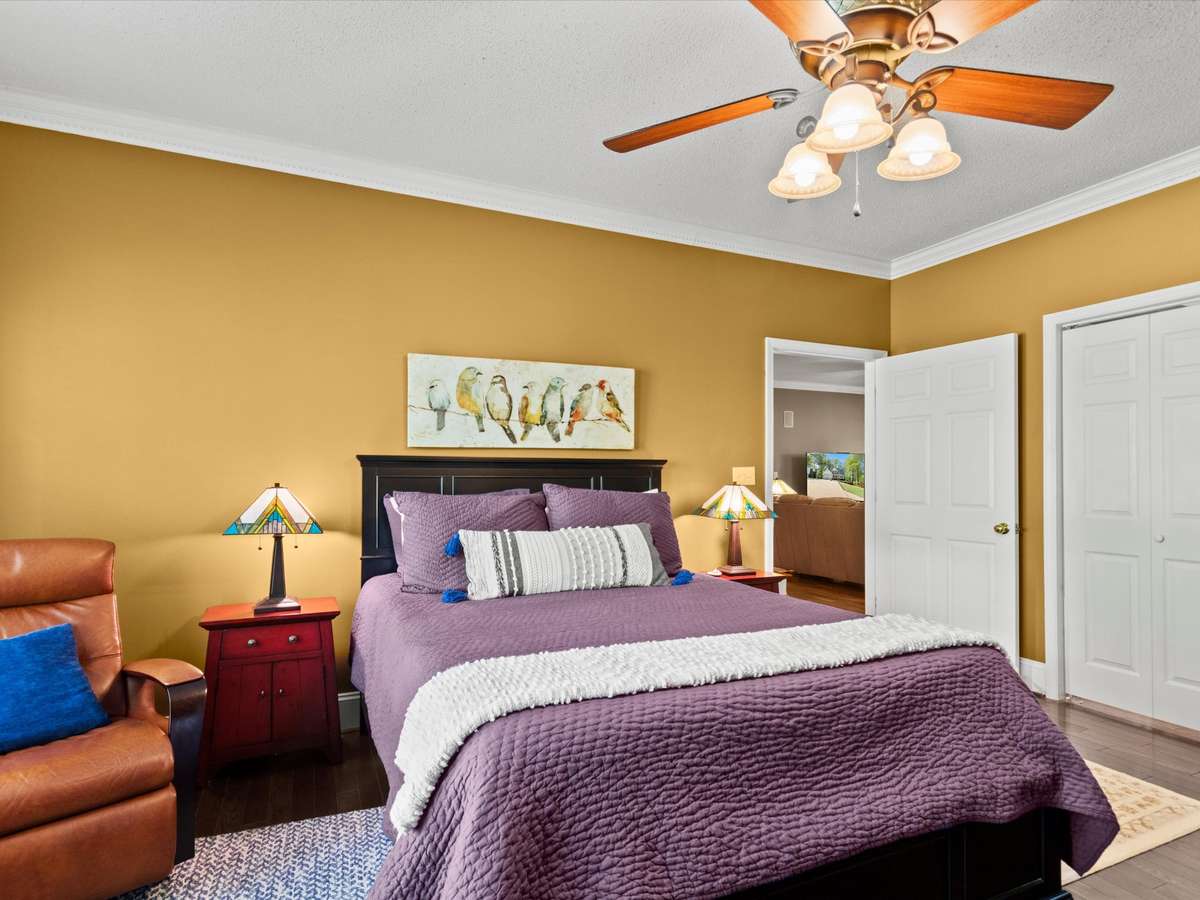 Primary Bedroom- Wood flooring, crown molding, ceiling fan, 9' ceiling