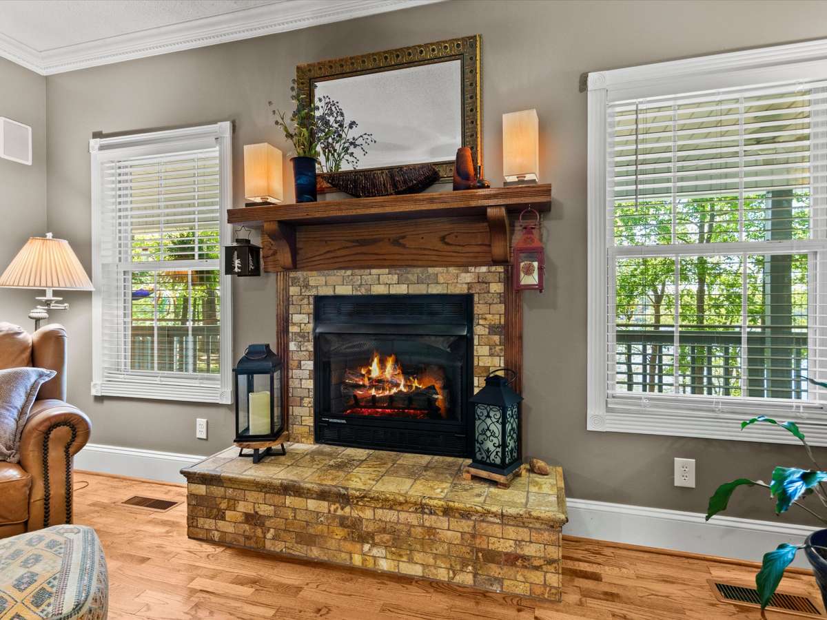 Living Room- Wood flooring, crown molding, ceiling fan, fireplace