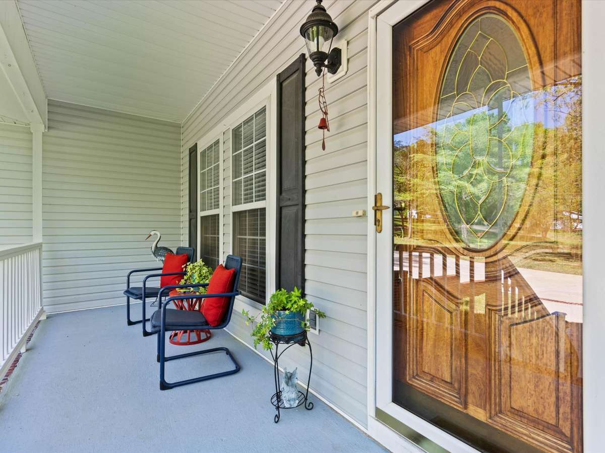 Front porch - Covered front porch with railing and home entry