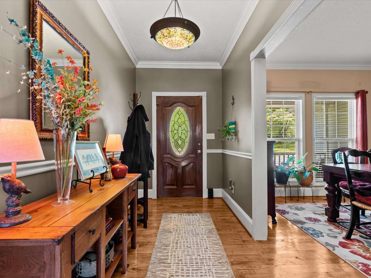 Foyer- Wood flooring, crown molding, chair rail