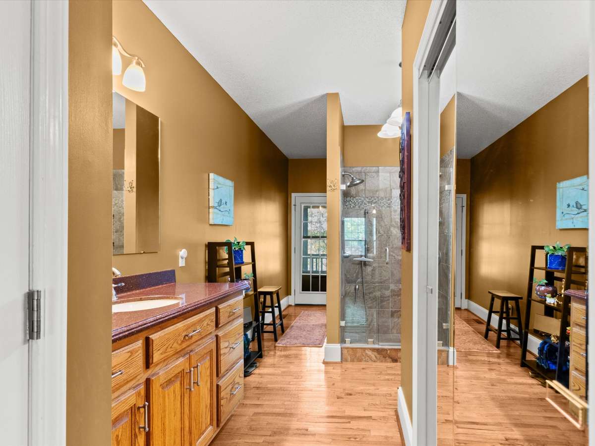 Primary Bathroom- wood flooring, two walk in closets