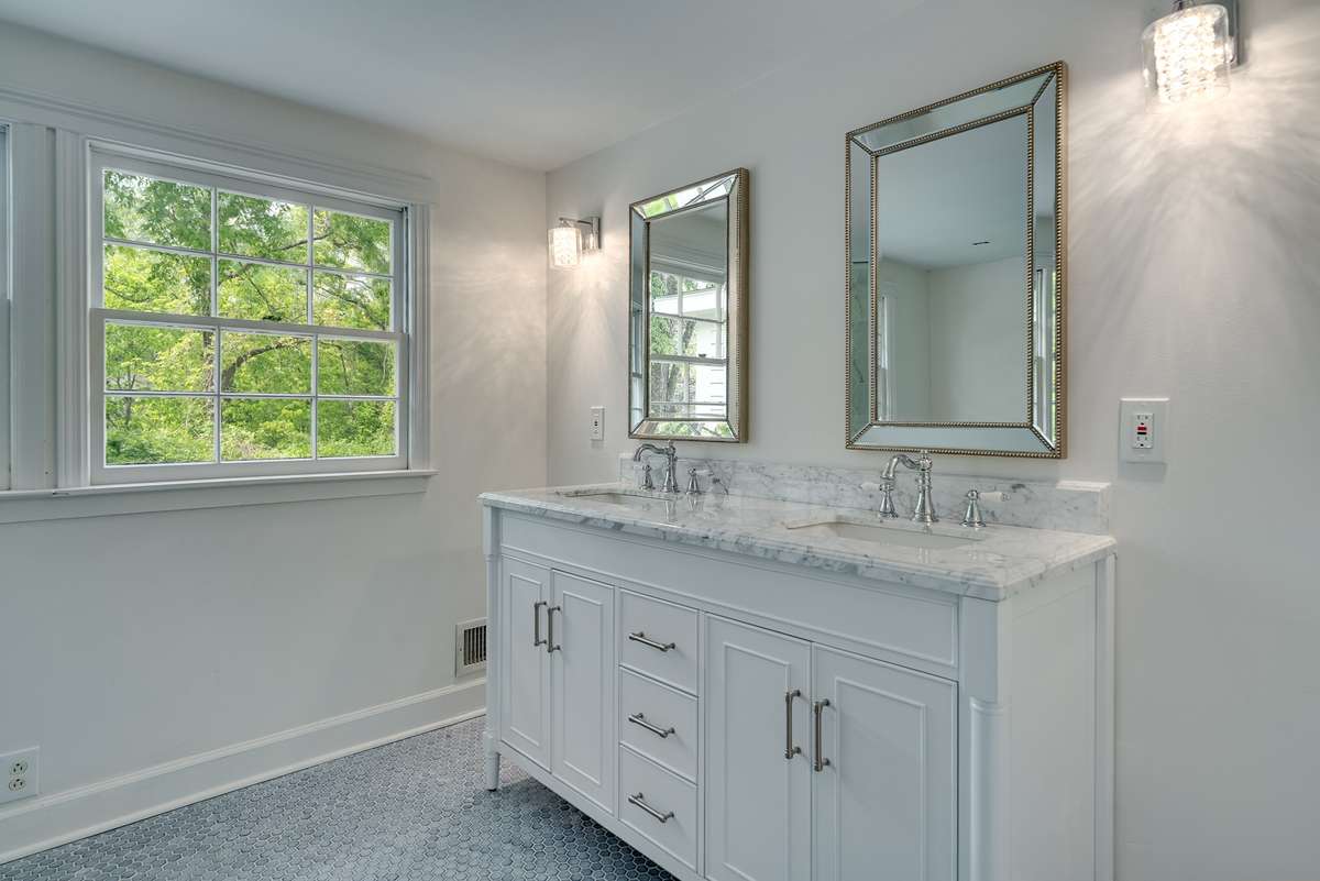 Upstairs full bathroom features a double vanity.