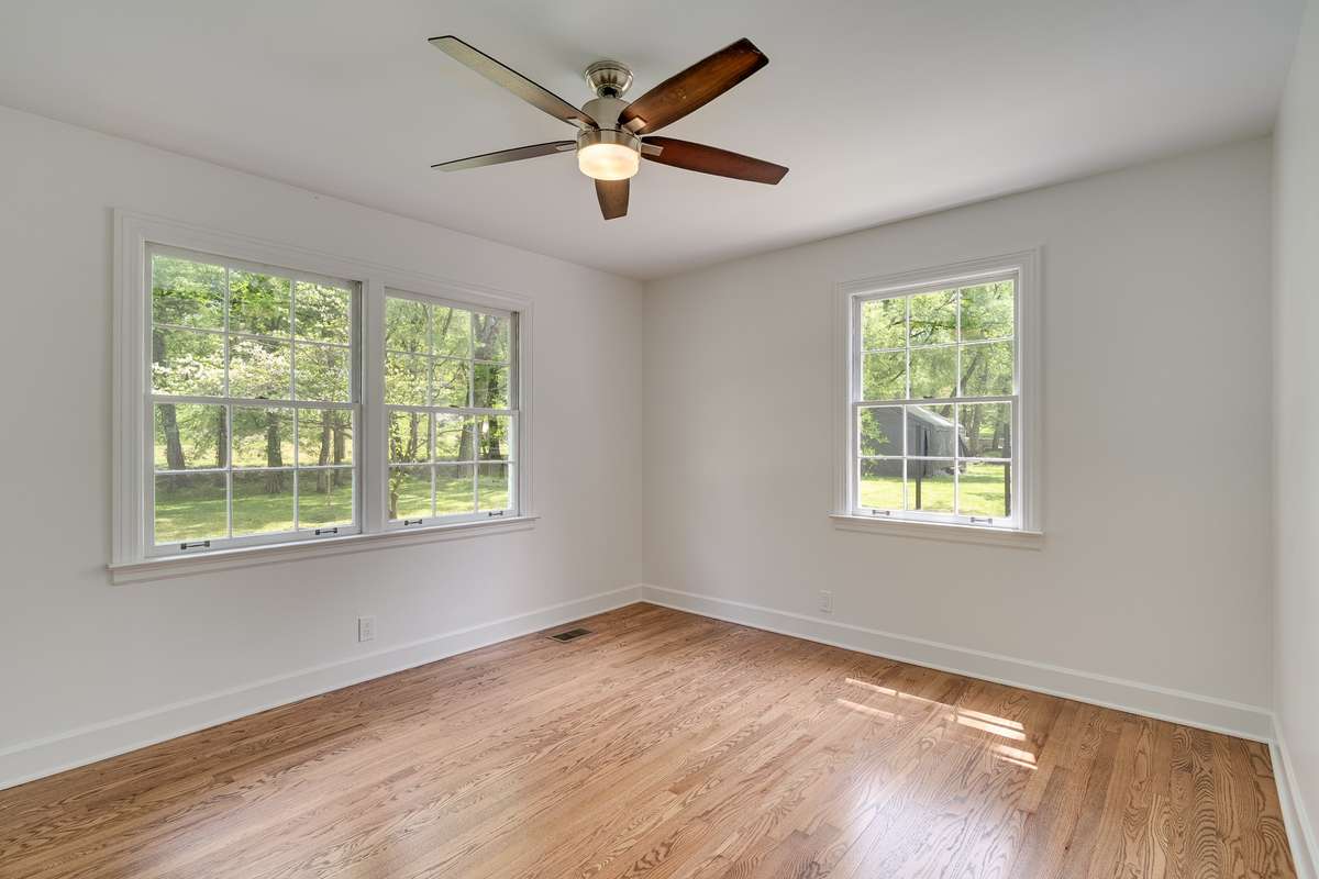 Guest Room downstairs. Wonderful light on the front side of home makes a great guest room or office. Full bathroom is next door in the hallway.