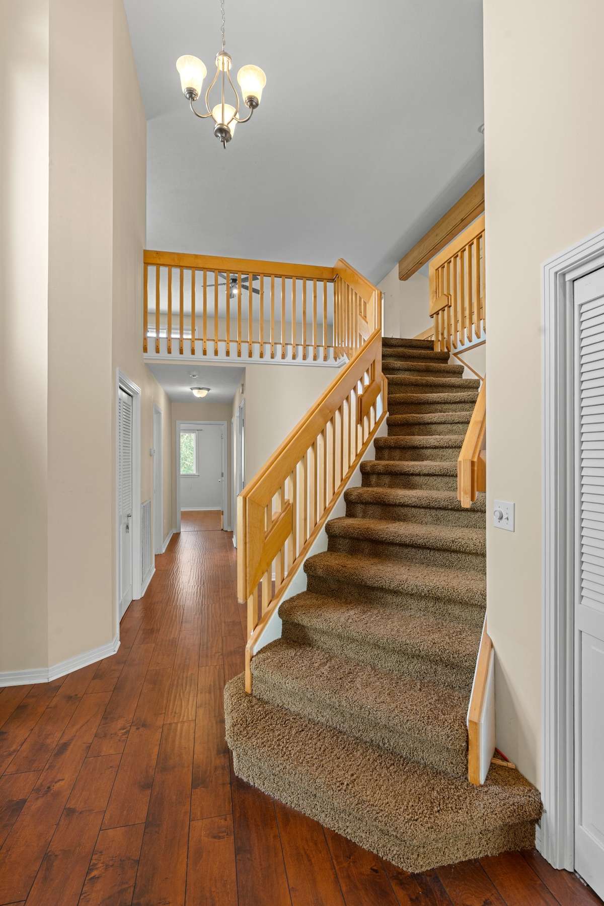 From front door looking to steps up to large bonus room and down the hall to the other bedrooms.