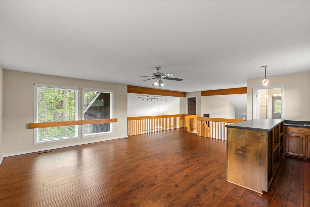 Railing on left overlooks the kitchen. Railing on the right overlooks the Foyer.