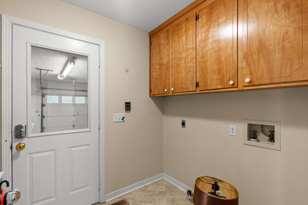 Utility room is closed off with door to hallway of home and door to garage.