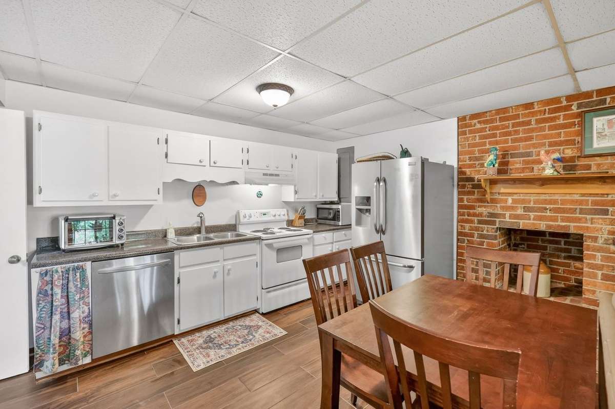 The downstairs area features it's own separate kitchen, living area, and gas fireplace with access to the backyard. Perfect for guest quarters, an in-law suite, or even used as an income producing space.