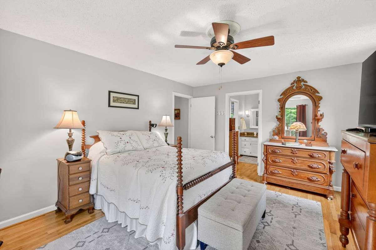 The primary bedroom is very spacious with a private bathroom, neutral paint colors, walk-in closet and large windows with views of both the front and side yards.