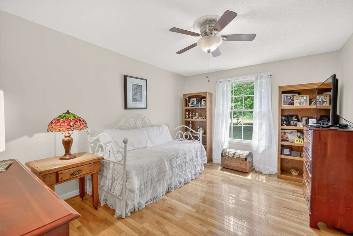 This is one of the three spacious bedrooms on the main level with each featuring hardwood floors and a view of the front yard.