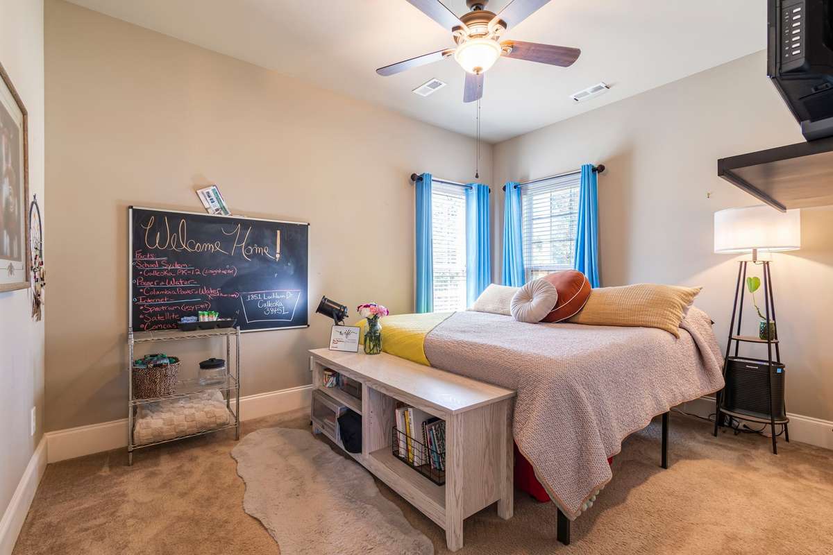 Second bedroom with floor to ceiling windows.